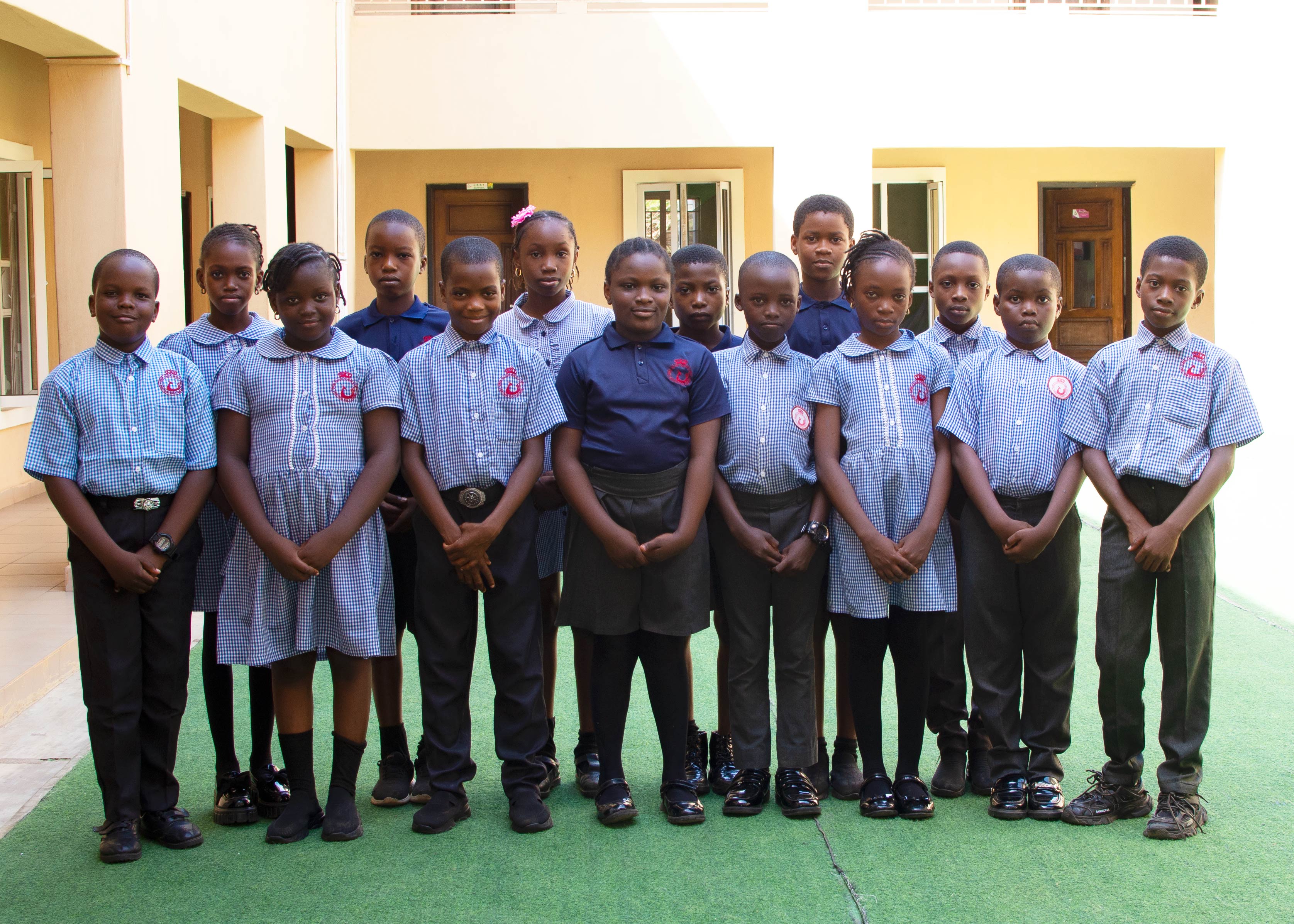 Primary pupils of Queen Jolade Schools gathered in the courtyard